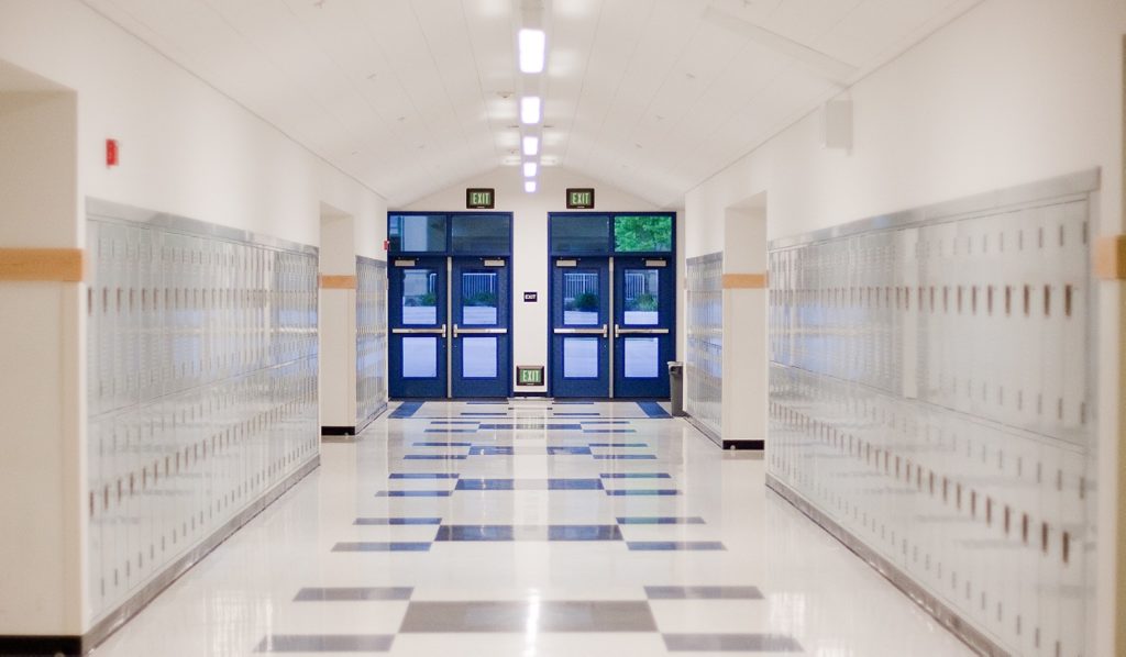high school hallway with blue doors and lockers