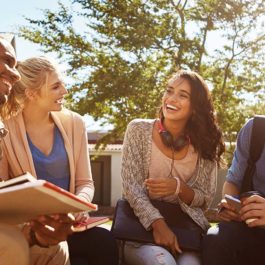 group of students sitting on university campus