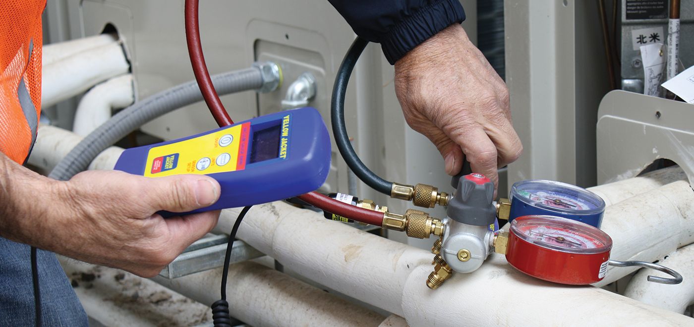 new Our Services HTS | Commercial & Industrial HVAC Systems, Parts, & Services Company Image of Man checking air pressure