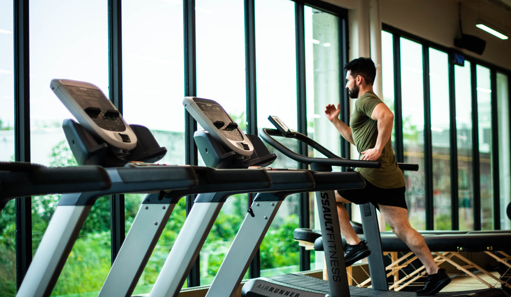 Man Running on a Treadmill in gym