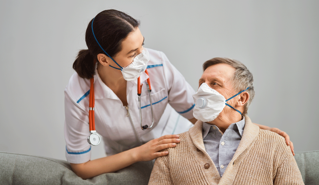 Nurse wearing mask with an elderly man wearing a mask