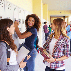Teenage girls standing by lockers in High School