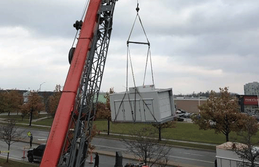 Image of a crane lifting a Dectron Unit