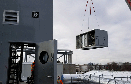 Image of a crane lifting a Haakon Air Handling Unit onto a rooftop