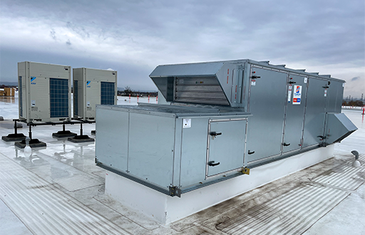 Image of the Tempeff Energy Recovery Ventilators (ERVs) on the rooftop of Derry Green Industrial. Behind the Tempeff units are the Daikin VRF Condensing Units.