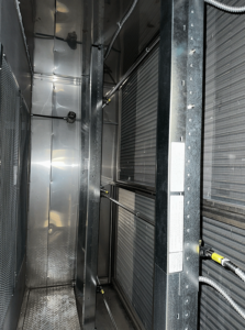 HTS Project CarletonUniversity Main 3 2025 1 HTS | Commercial & Industrial HVAC Systems, Parts, & Services Company Inside view of HVAC unit with spray nozzles and coil panels.