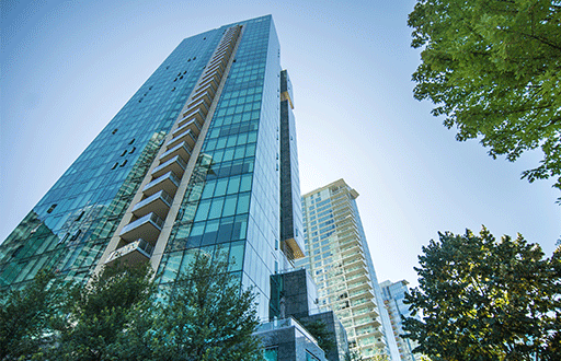 a tall glass building with trees
